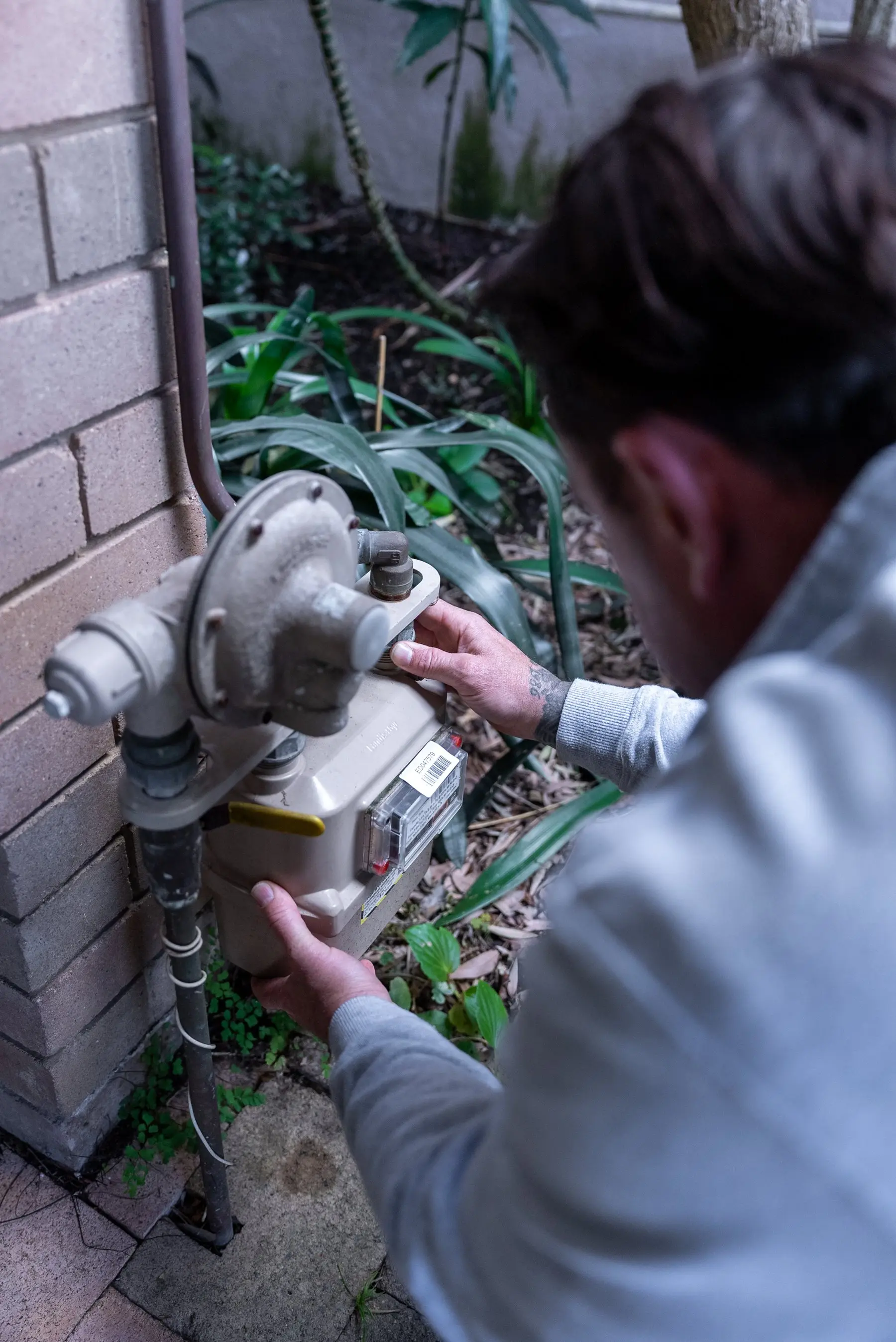 A Plumbwell gas fitter working on a meter in Balmain