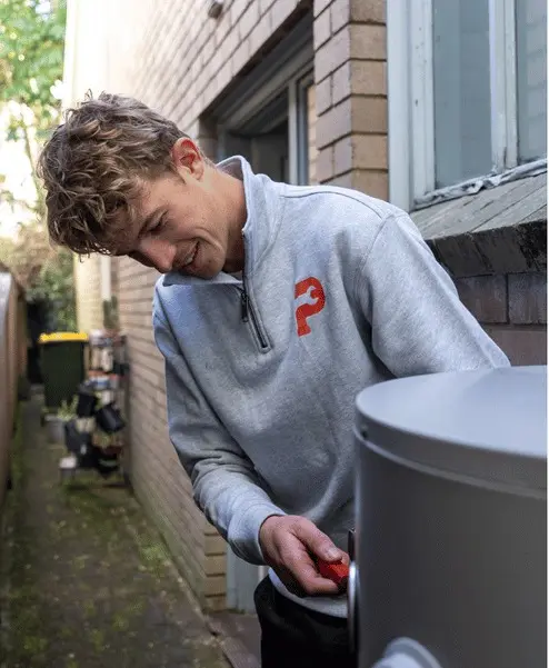 A Plumbwell plumber servicing a hot water cylinder