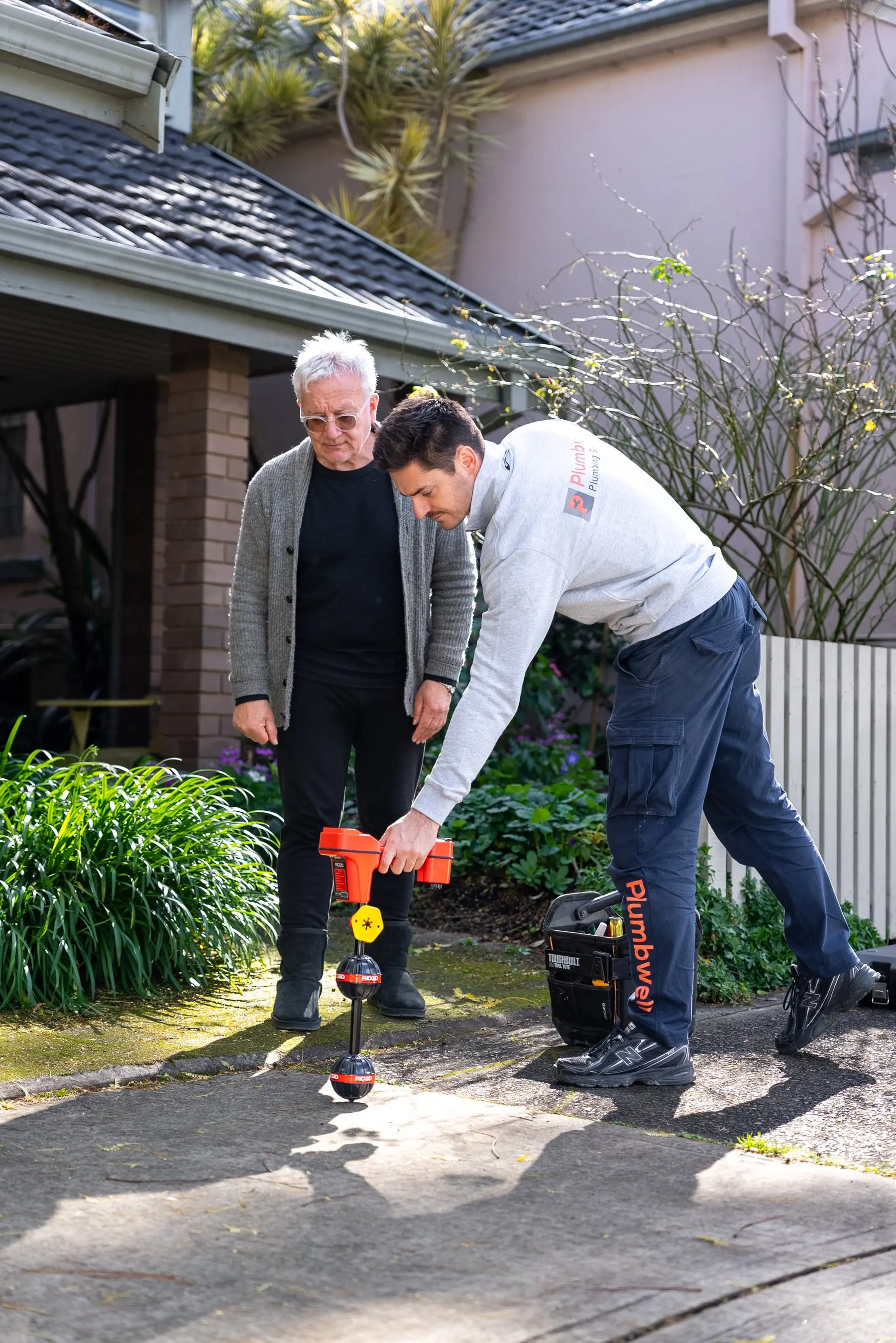 A Plumbwell plumber clearing a blocked drain in Sydney