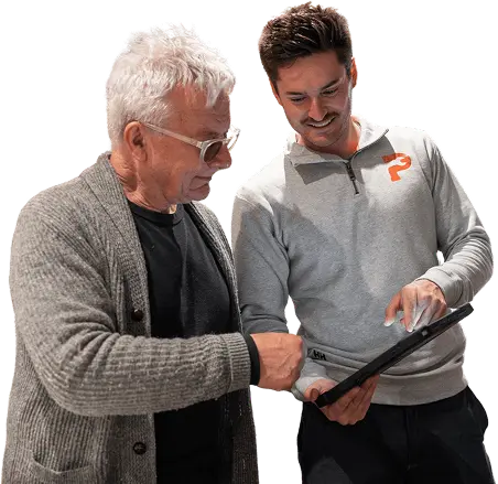 A Plumbwell plumber talking a happy customer through the job on a tablet